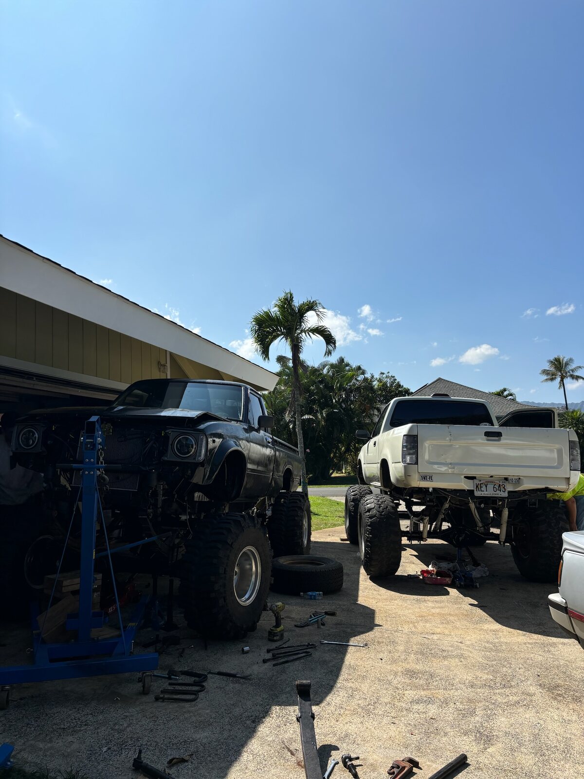 Two Toyota project trucks outside a workshop