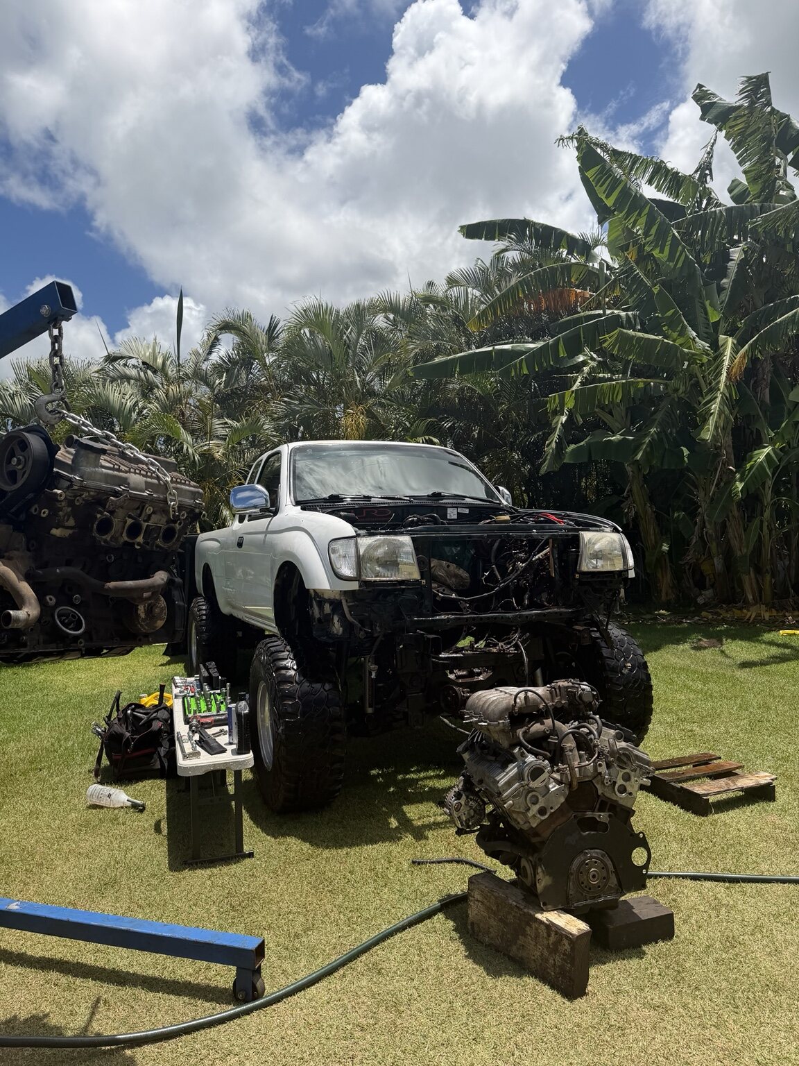 White Toyota Tacoma during outdoor engine service